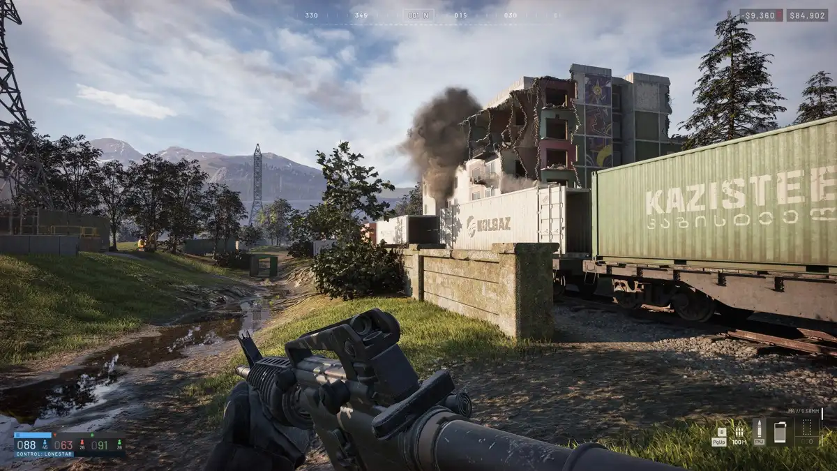 First-person WARDOGS gameplay beside a damaged apartment building and freight train